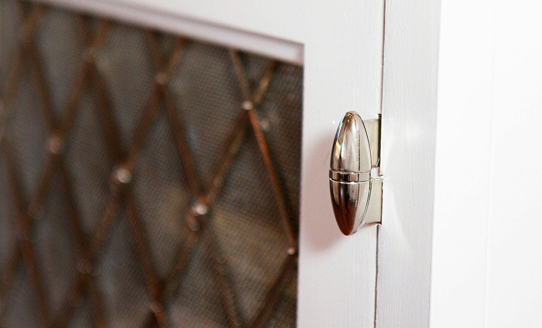 Silver cabinet door hinge created by GME builders in Charlottesville, Virginia